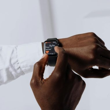 Close-up of a person interacting with a smartwatch for health tracking indoors.