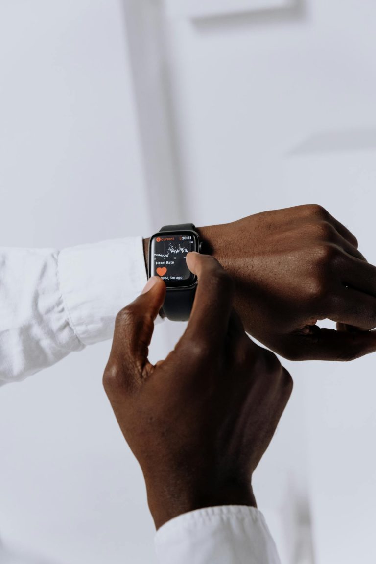 Close-up of a person interacting with a smartwatch for health tracking indoors.